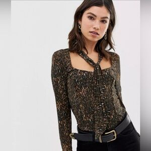 Free People leopard print top with a scarf around the neck